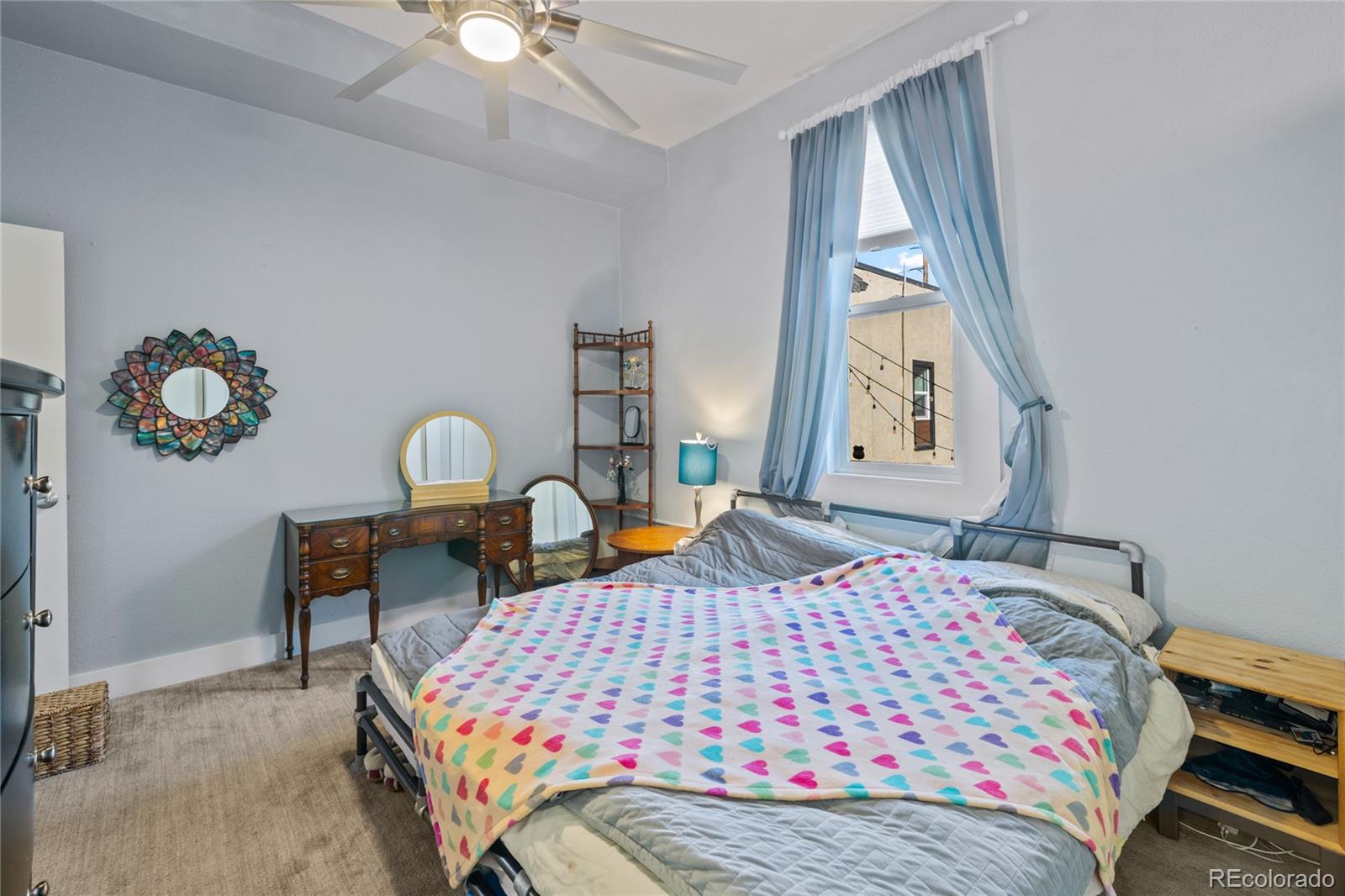 3460 North Pecos Street, Unit 1 Denver, CO 80211 - Photo 18 of 45 a bedroom with a bed a window and dresser