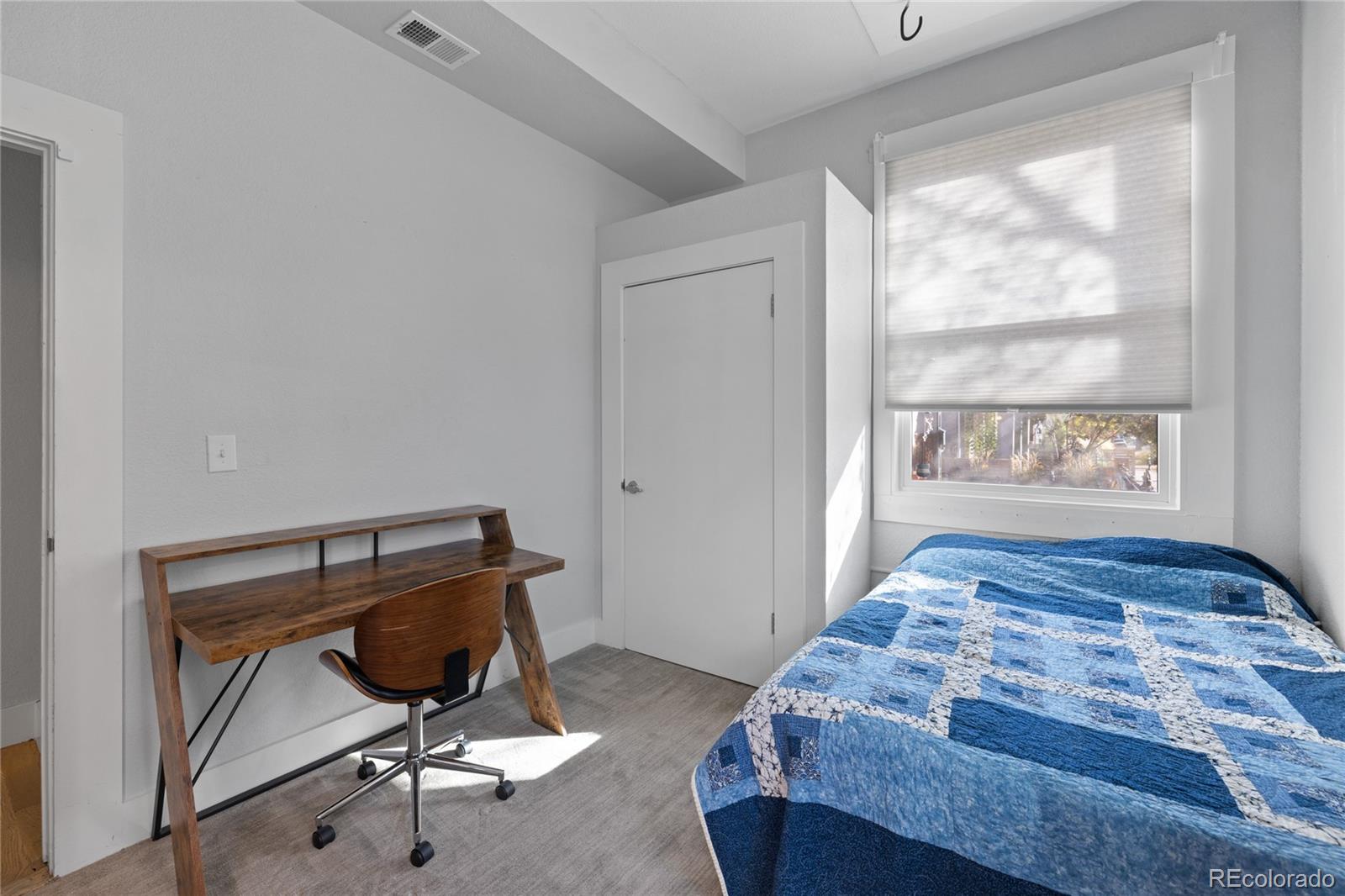 3460 North Pecos Street, Unit 1 Denver, CO 80211 - Photo 21 of 45 a bedroom with a bed and a window