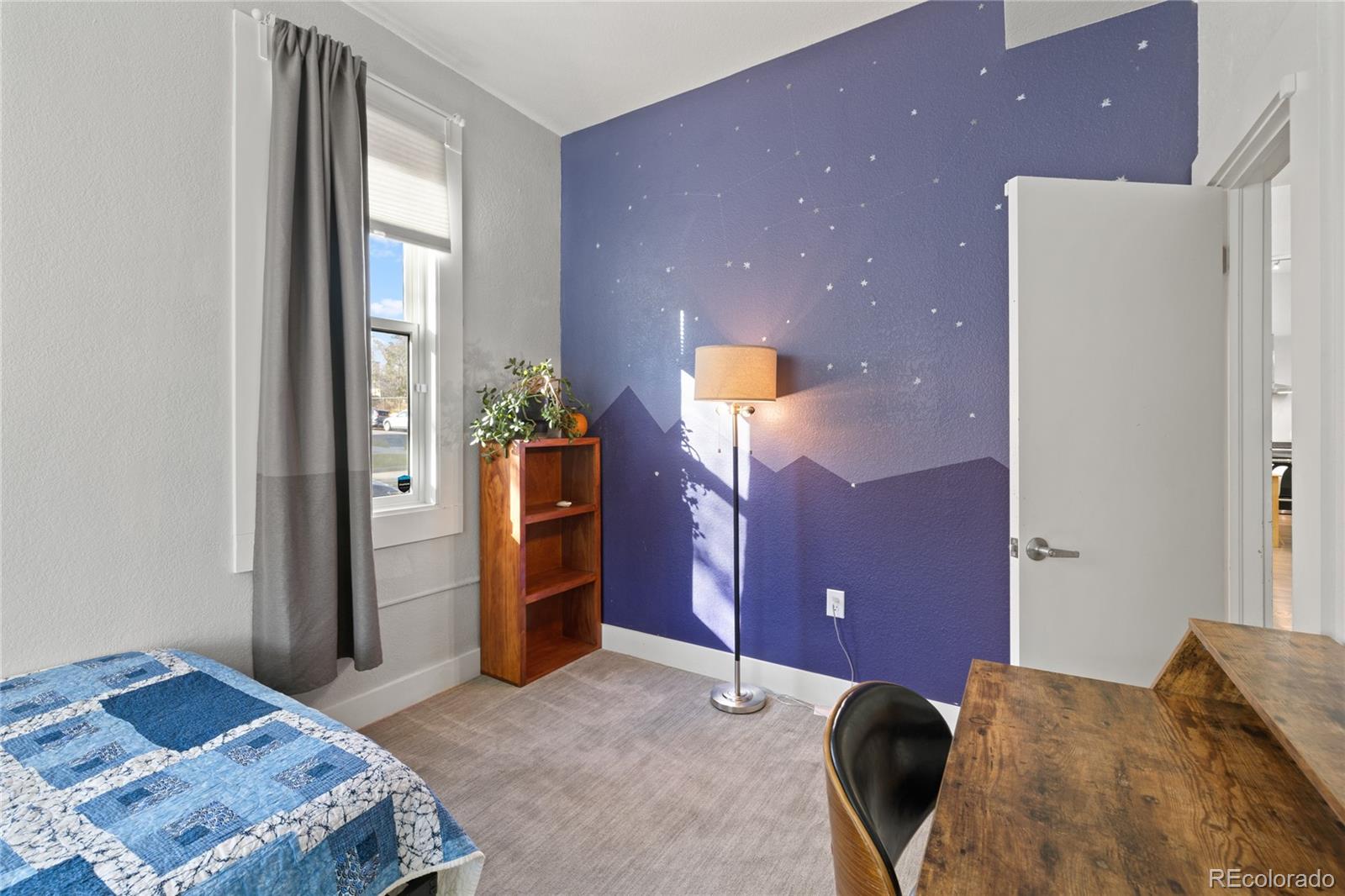 3460 North Pecos Street, Unit 1 Denver, CO 80211 - Photo 22 of 45 a bedroom with a bed and a dresser with mirror