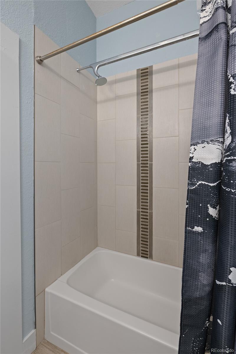 3460 North Pecos Street, Unit 1 Denver, CO 80211 - Photo 24 of 45 a bathroom with a bathtub and a shower