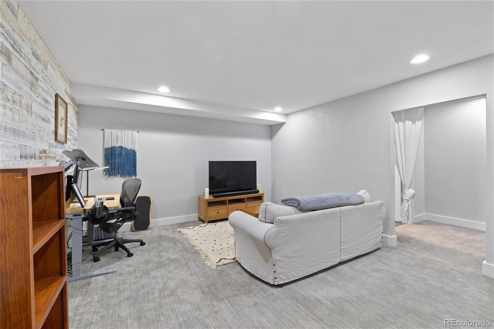 3460 North Pecos Street, Unit 1 Denver, CO 80211 - Photo 26 of 45 a living room with furniture and a flat screen tv