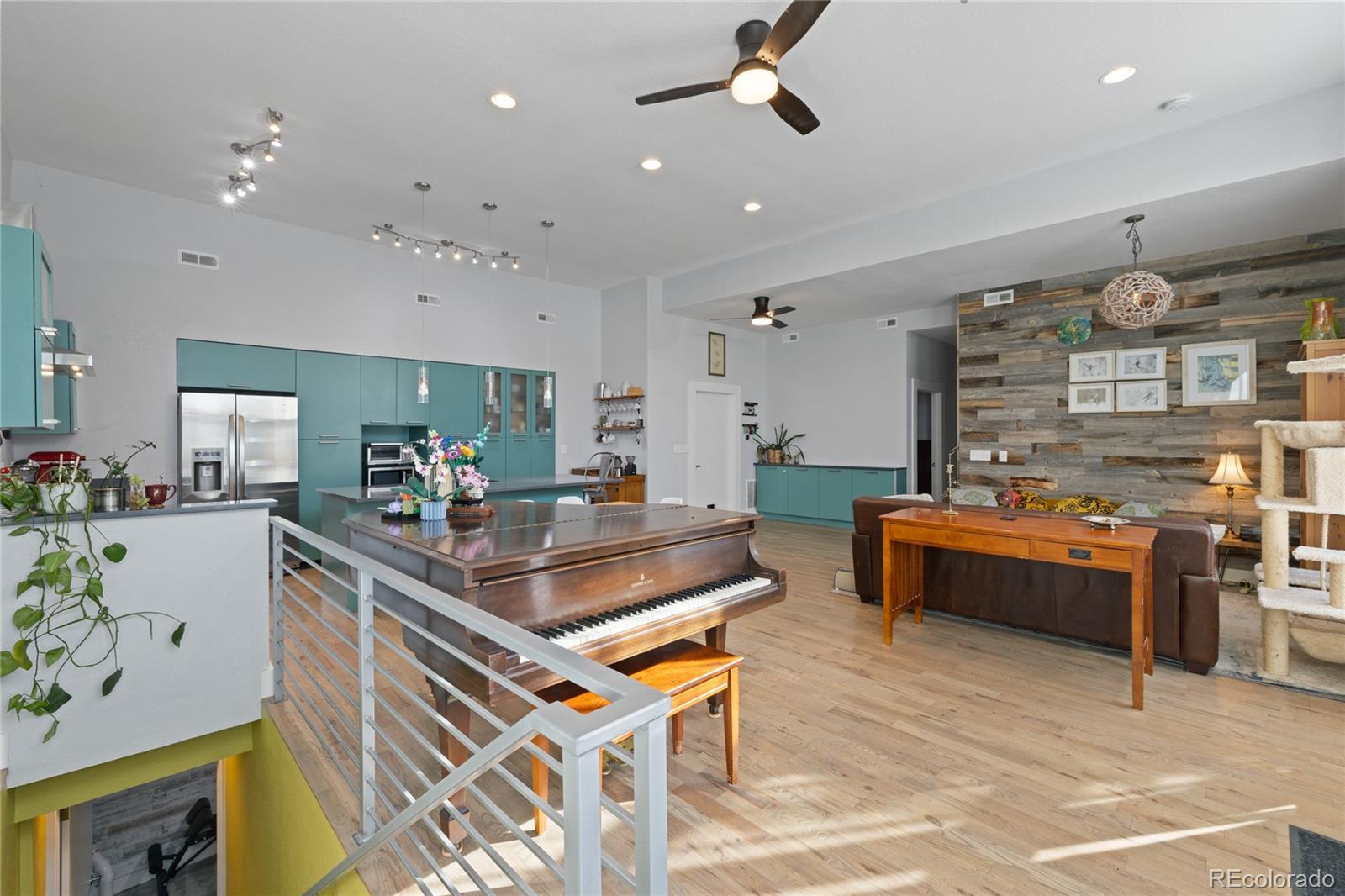 3460 North Pecos Street, Unit 1 Denver, CO 80211 - Photo 6 of 45 a living room with stainless steel appliances kitchen island granite countertop furniture and a kitchen view