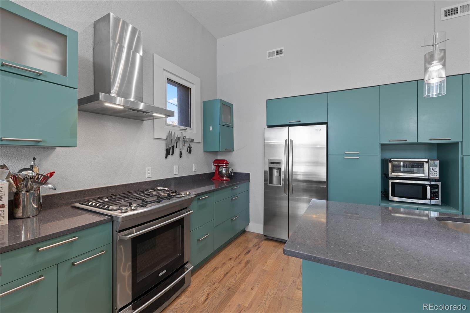 3460 North Pecos Street, Unit 1 Denver, CO 80211 - Photo 10 of 45 a kitchen with stainless steel appliances a stove a refrigerator and a sink