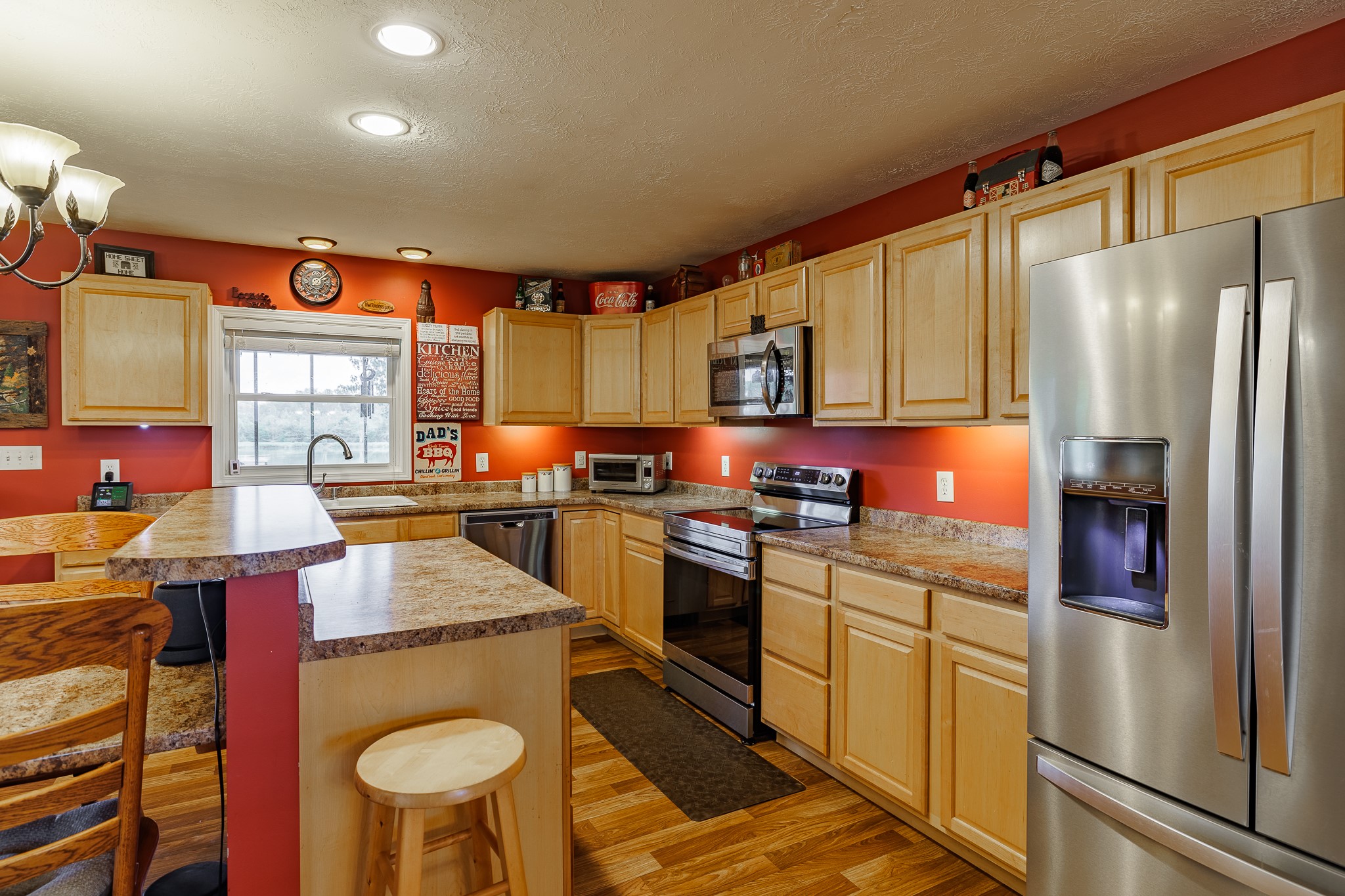 625 Happy Hollow Road Washington, GA 30673 - Photo 15 of 50 a kitchen with stainless steel appliances granite countertop a refrigerator a stove top oven a sink dishwasher and white cabinets with wooden floor