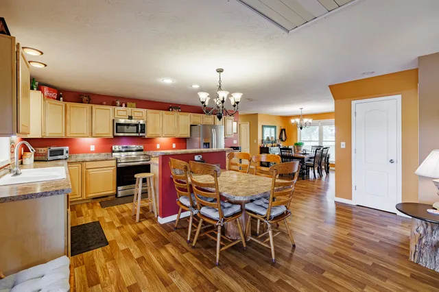 a view of a dining room with furniture and chandelier