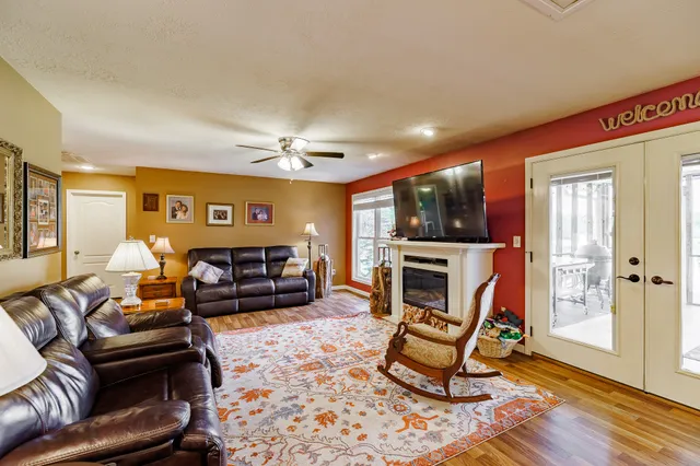 a living room with furniture a fireplace and a flat screen tv
