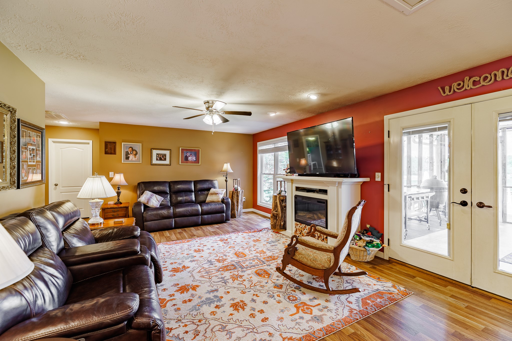 625 Happy Hollow Road Washington, GA 30673 - Photo 19 of 50 a living room with furniture a fireplace and a flat screen tv