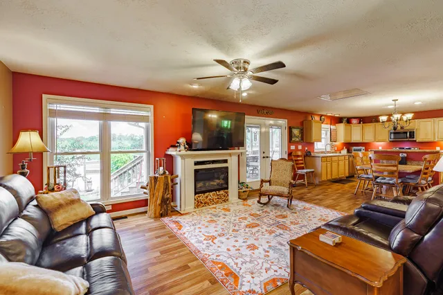 a living room with furniture fireplace and a large window