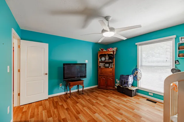 a bedroom with furniture and a flat screen tv