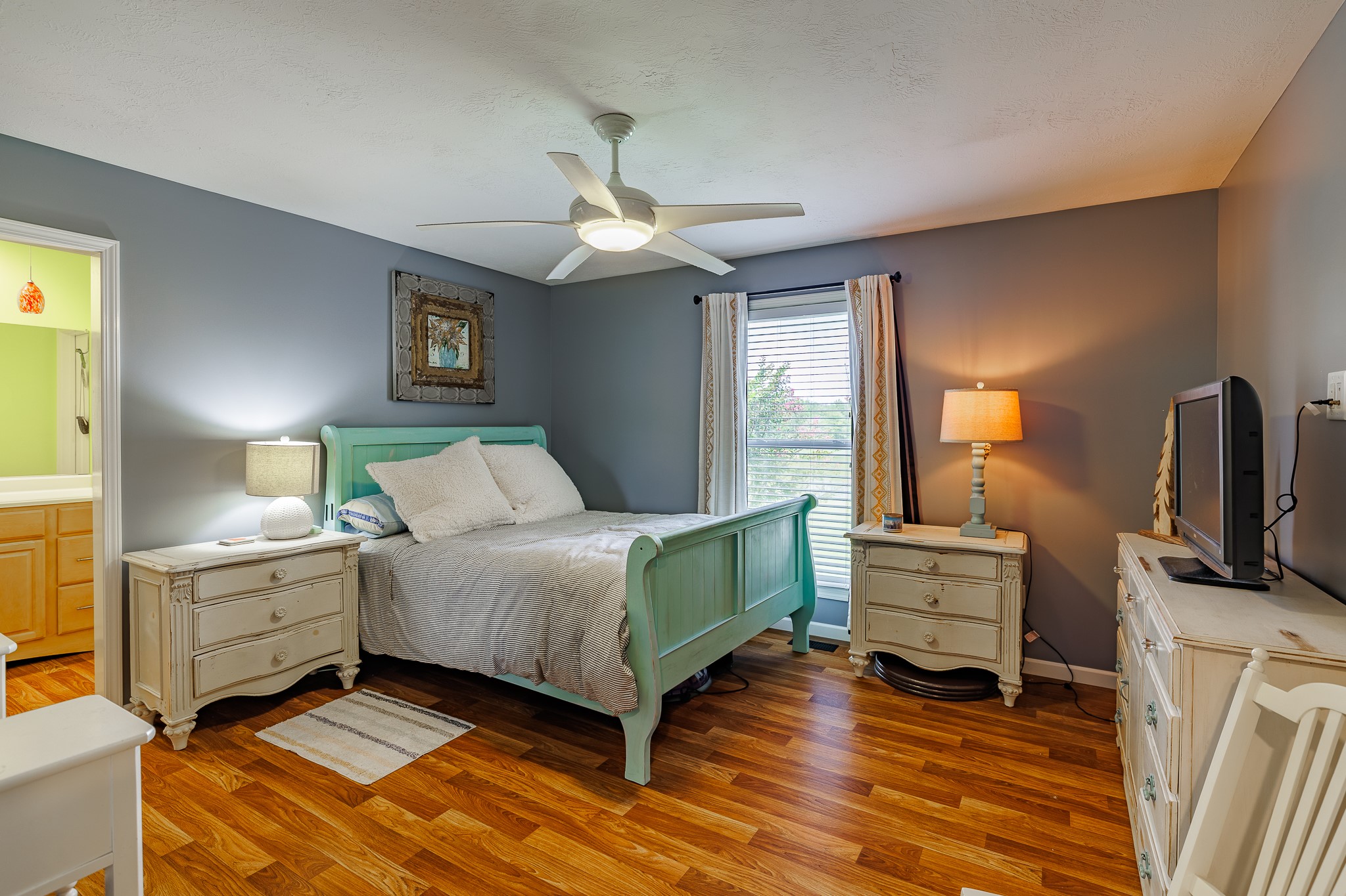 625 Happy Hollow Road Washington, GA 30673 - Photo 29 of 50 a bedroom with a bed and a flat tv screen on dresser