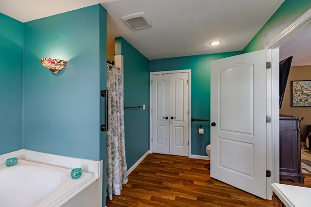 a view of bathroom with a bathtub a sink and mirror