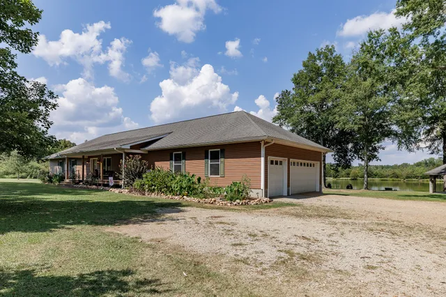 a view of a field with trees in the background