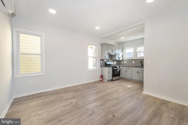 a view of a kitchen with a sink and dishwasher a refrigerator with wooden floor