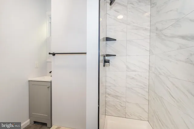 a bathroom with a shower and a glass door