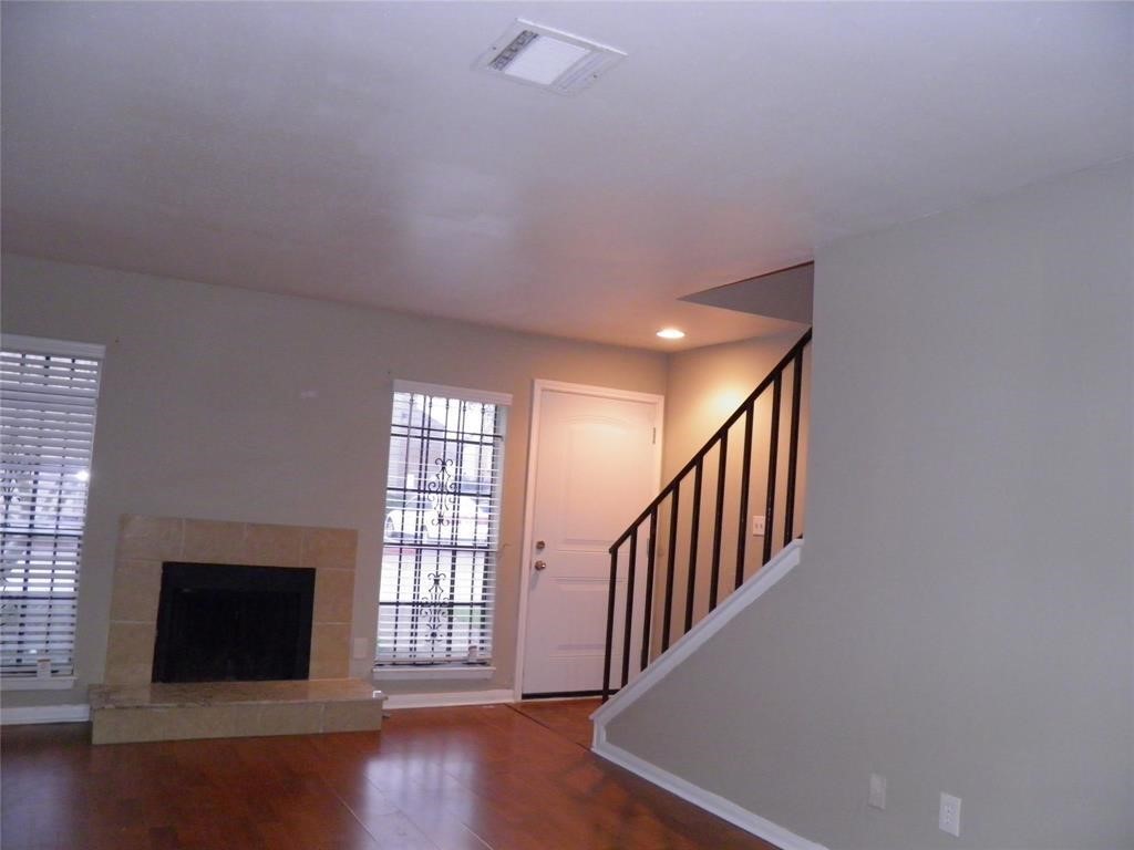 9901 Sharpcrest Street, Unit D1 Houston, TX 77036 - Photo 7 of 8 a view of an empty room with wooden floor and a window