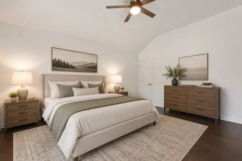 a bedroom with a bed and a chandelier