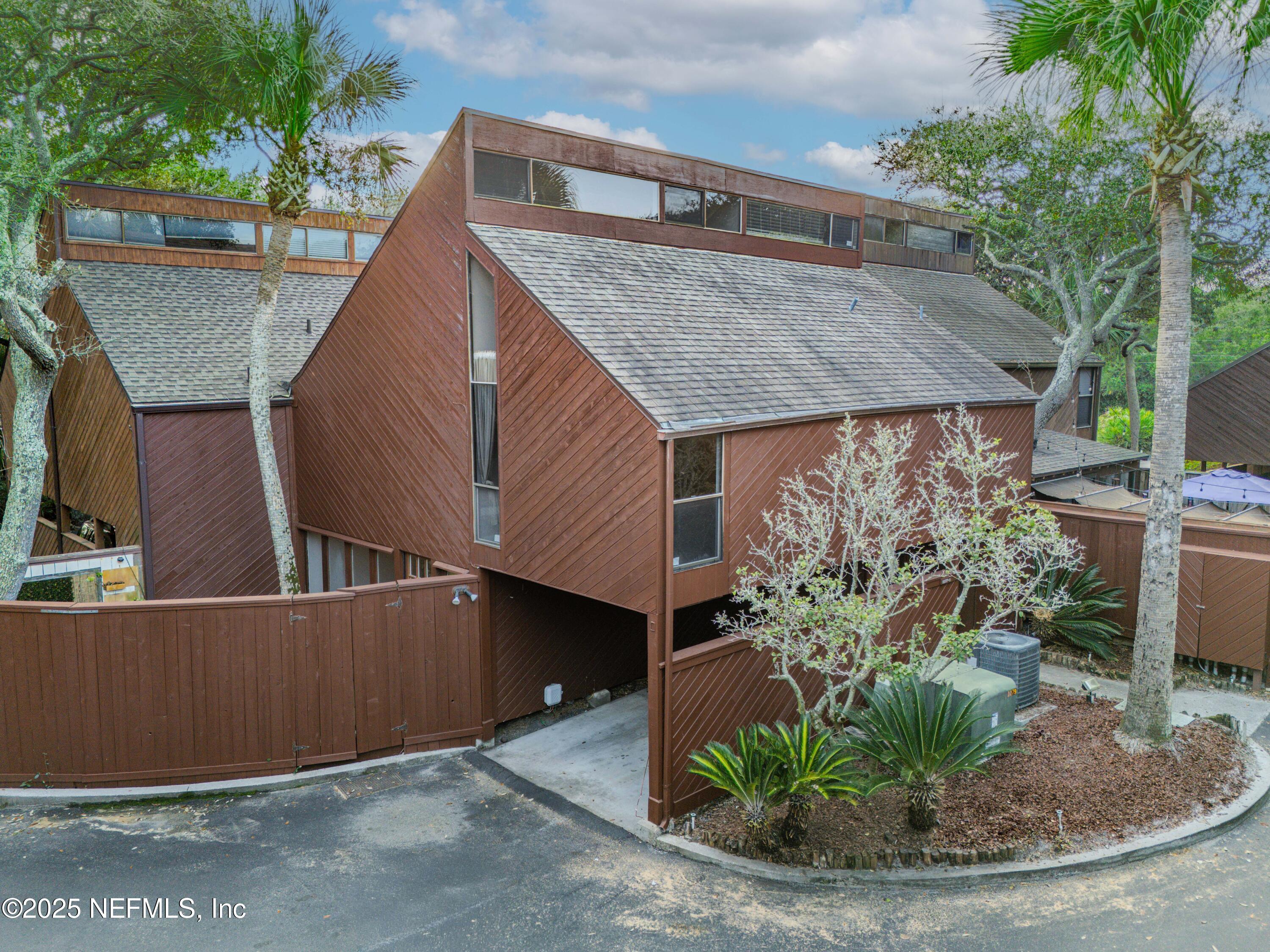 a view of a house with brick walls and potted plants