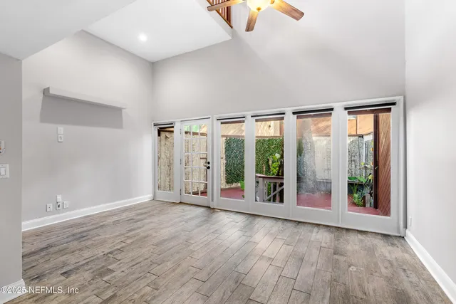 a view of a room with a hanging light and air conditioner