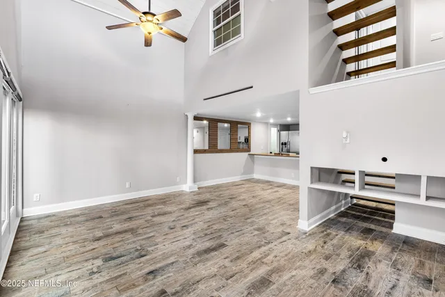a bedroom with a bed a couch and a chandelier