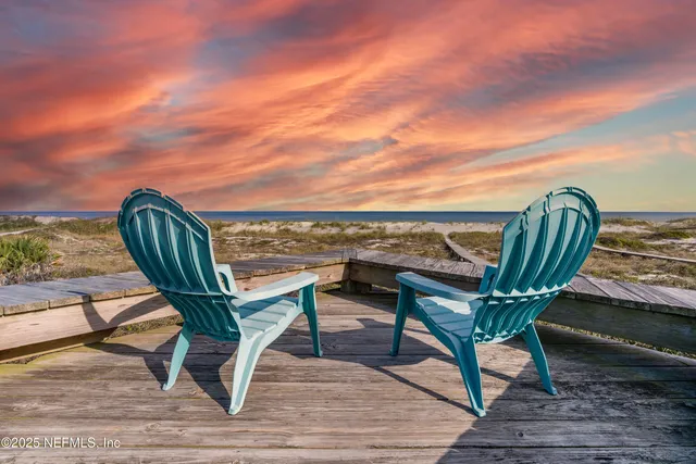 a view of a hallway with wooden floor and windows