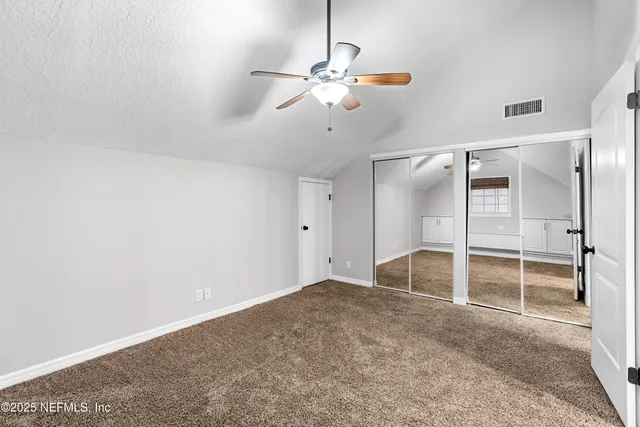 a view of a house with large trees