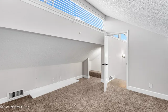an aerial view of a house with a yard and plants