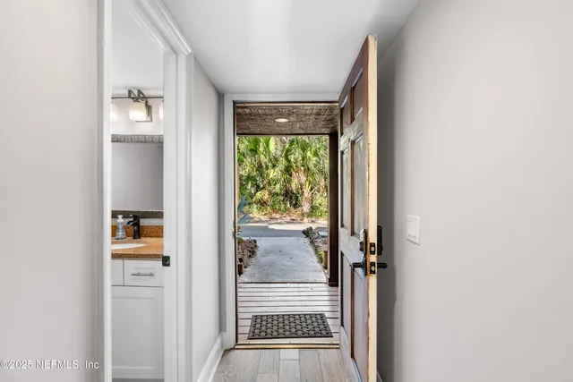 a large kitchen with a large window and stainless steel appliances