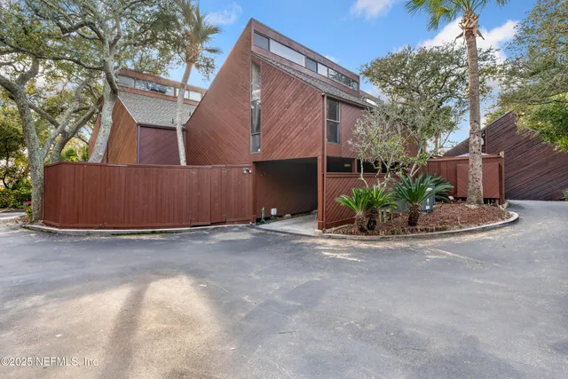a backyard of a house with outdoor seating