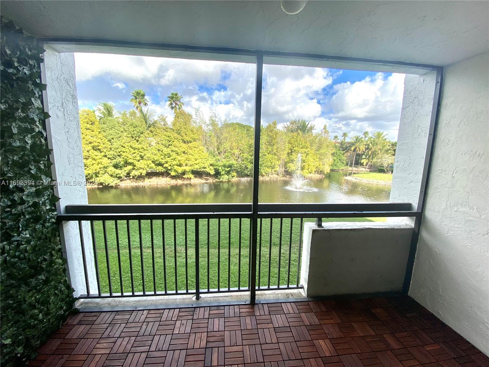 721 North Pine Island Road, Unit 213 Plantation, FL 33324 - Photo 11 of 11 a view of a balcony with wooden floor