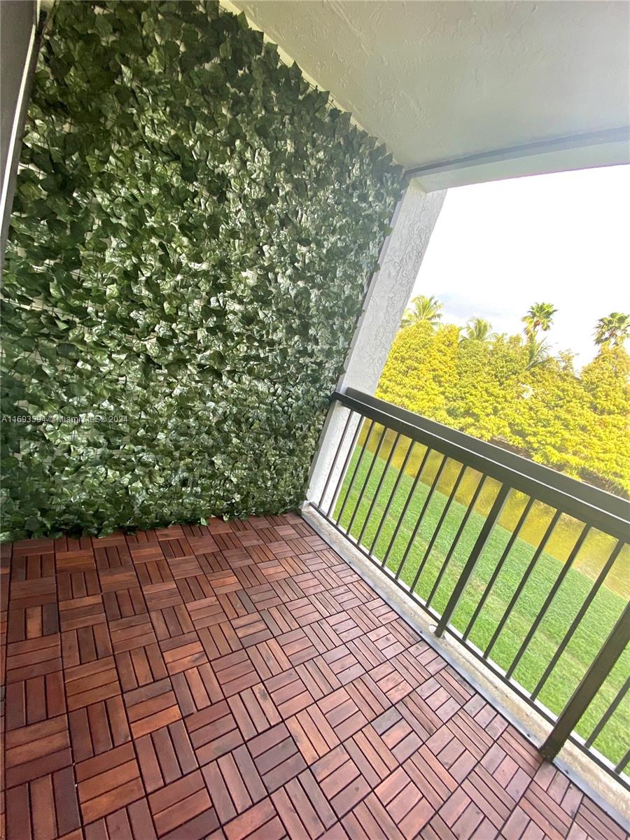 721 North Pine Island Road, Unit 213 Plantation, FL 33324 - Photo 10 of 11 a view of balcony with wooden floor