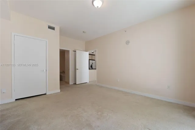 an empty room with closet area