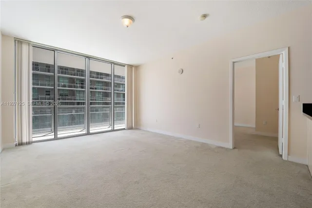 a view of empty room with a ceiling fan