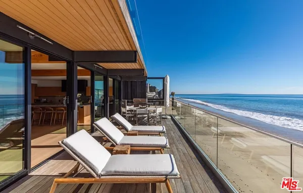 a view of balcony with couch and chairs
