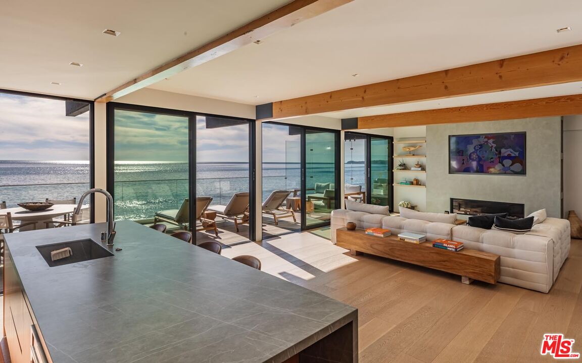24548 Malibu Road Malibu, CA 90265 - Photo 11 of 28 a bedroom with furniture and large windows