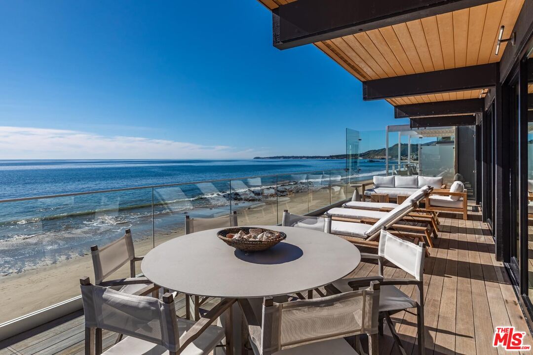 24548 Malibu Road Malibu, CA 90265 - Photo 12 of 28 a table and chairs in front of a house