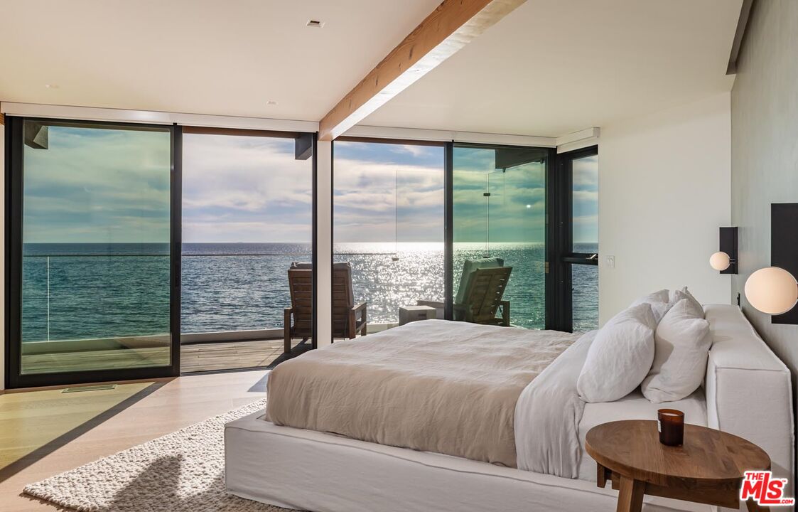24548 Malibu Road Malibu, CA 90265 - Photo 16 of 28 a bedroom with a large bed and a large window