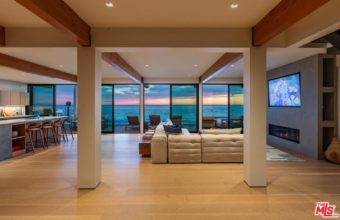 24548 Malibu Road Malibu, CA 90265 - Photo 24 of 28 a living room with large windows