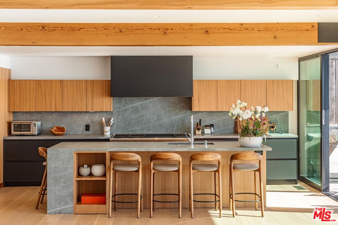 24548 Malibu Road Malibu, CA 90265 - Photo 9 of 28 a kitchen with a table and chairs in it