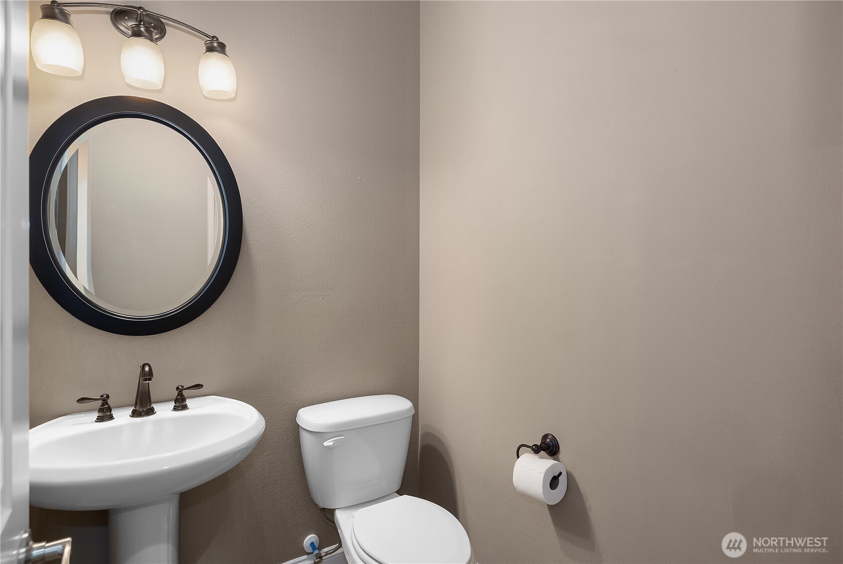 8265 Orcas Loop Northeast Lacey, WA 98516 - Photo 16 of 39 a bathroom with a toilet a sink and a mirror