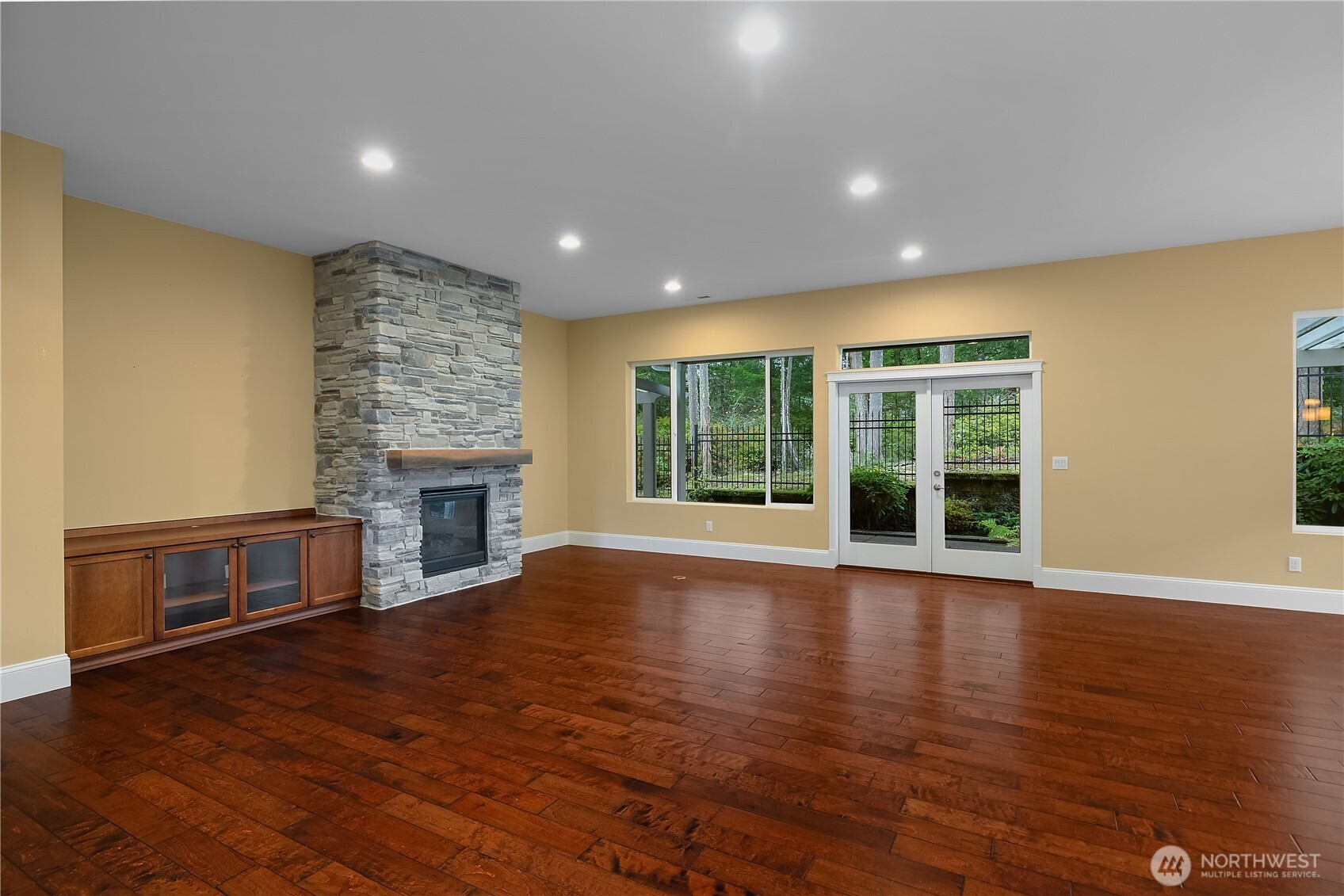 8265 Orcas Loop Northeast Lacey, WA 98516 - Photo 24 of 39 a view of an empty room with wooden floor and a fireplace