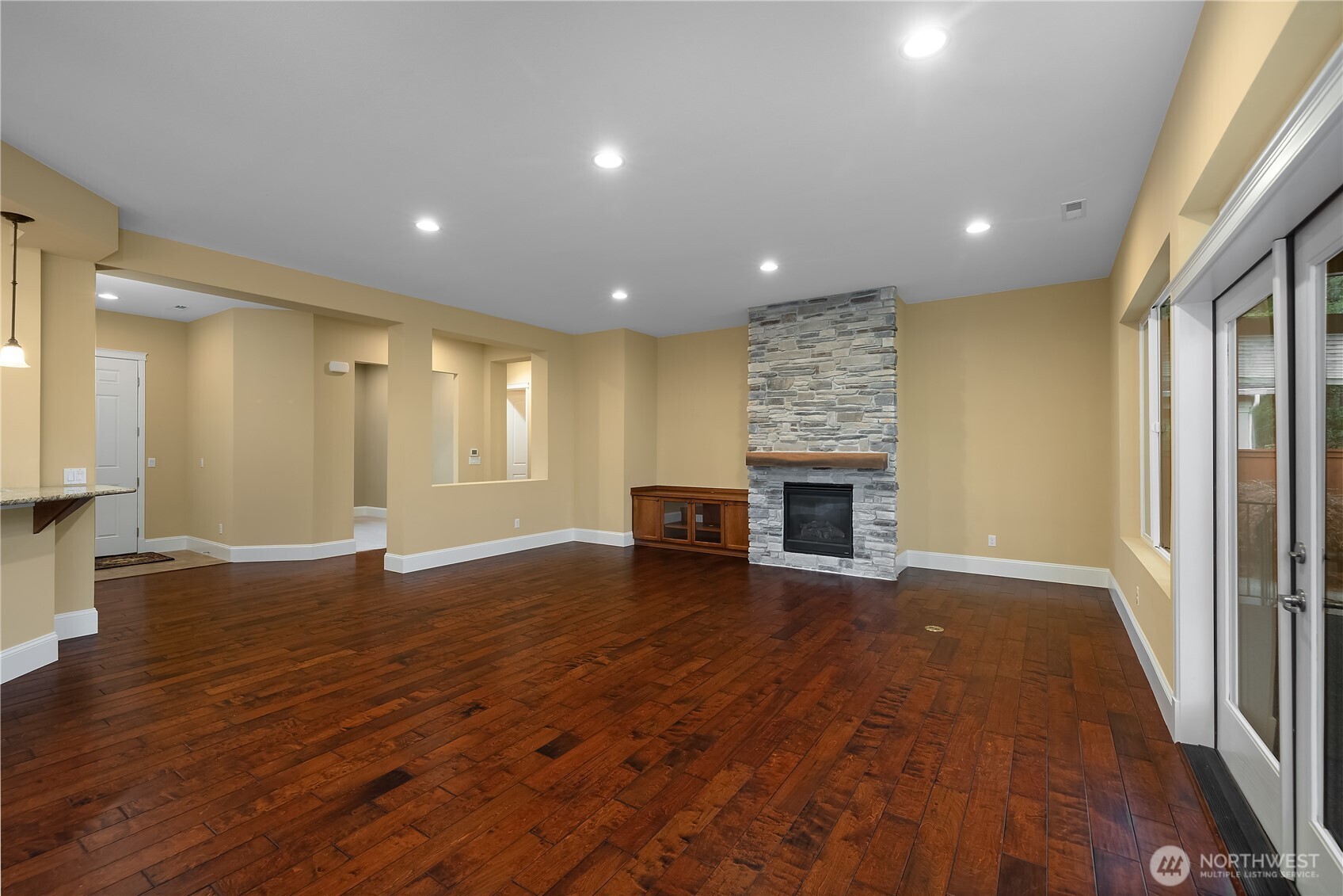 8265 Orcas Loop Northeast Lacey, WA 98516 - Photo 25 of 39 an empty room with wooden floor and fireplace