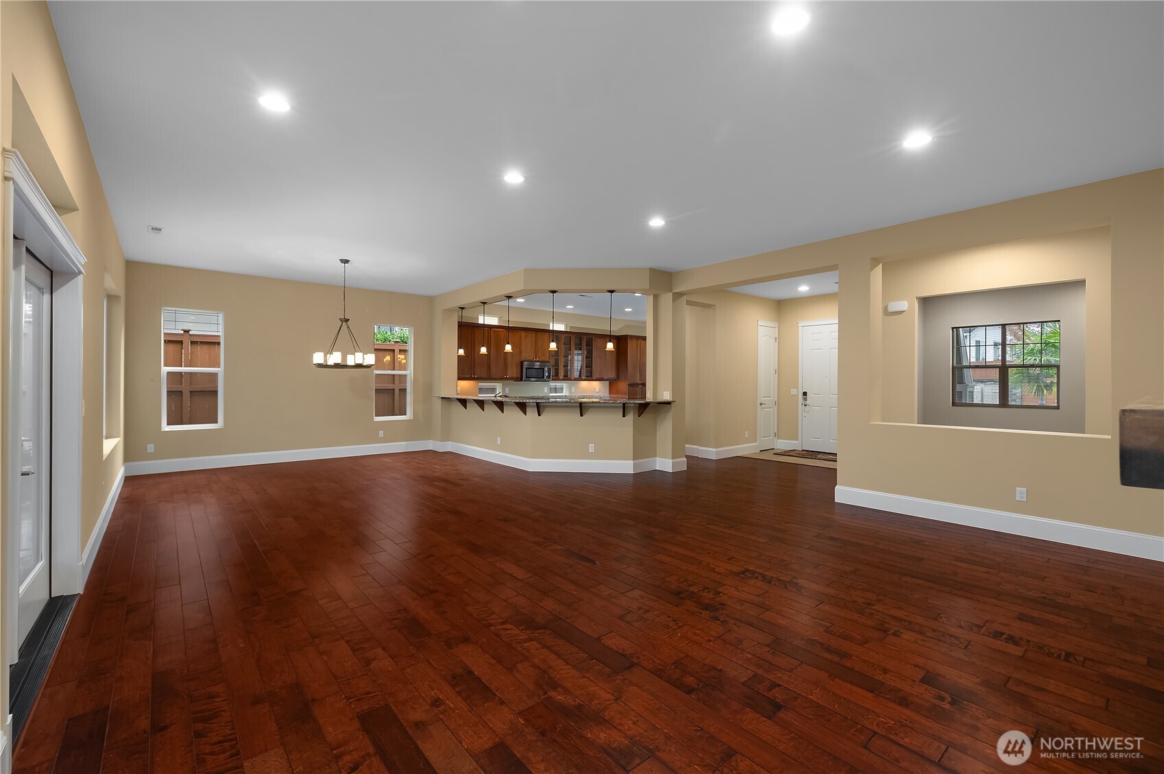 8265 Orcas Loop Northeast Lacey, WA 98516 - Photo 26 of 39 an empty room with wooden floor and windows