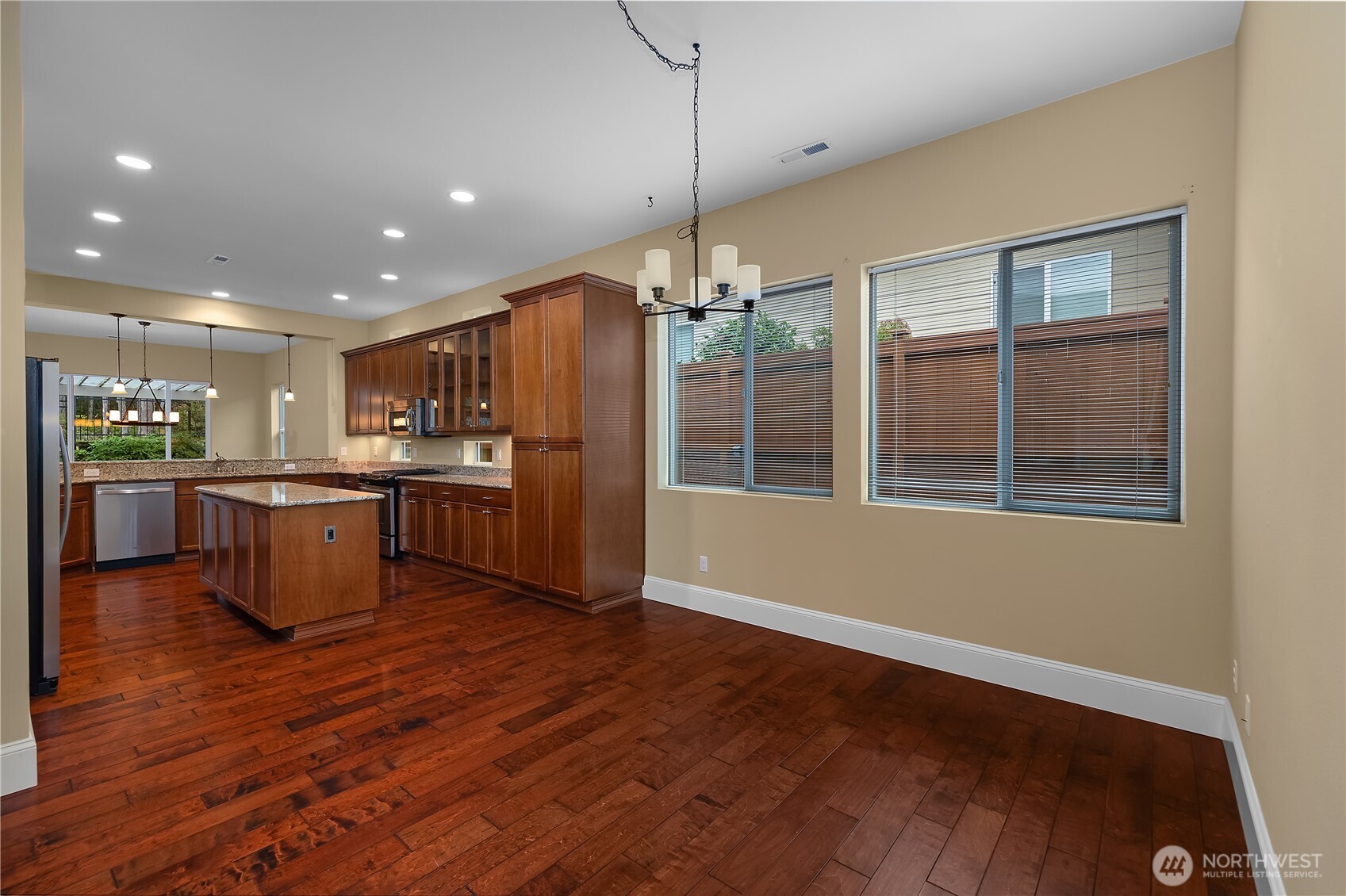8265 Orcas Loop Northeast Lacey, WA 98516 - Photo 29 of 39 a kitchen with stainless steel appliances kitchen island granite countertop wooden floors and large cabinets