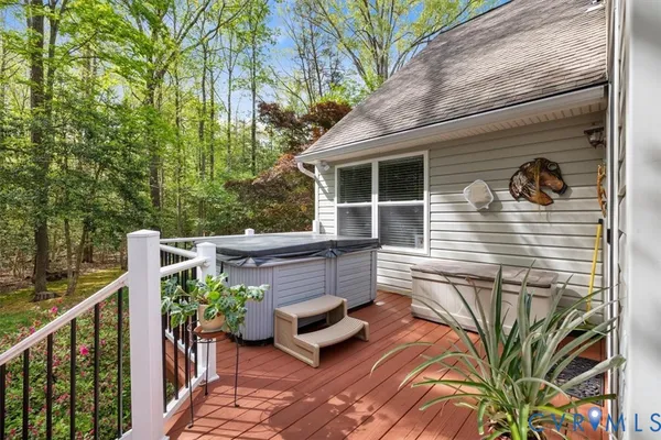 a front view of a house with a yard and potted plants
