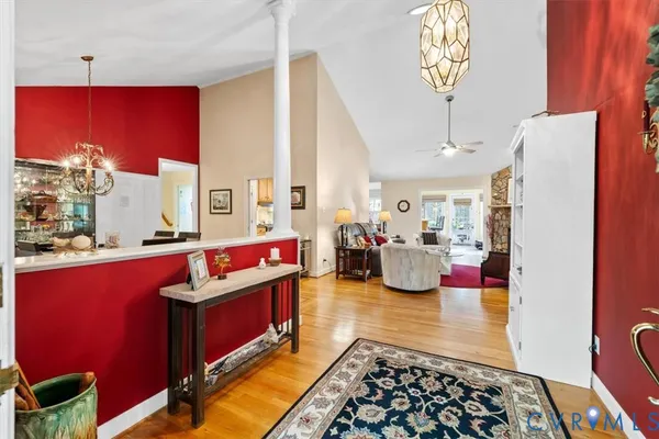 a living room with fireplace furniture and a chandelier