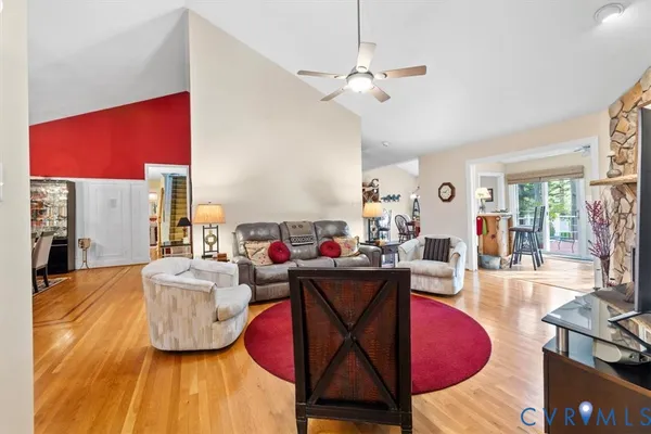 a living room with furniture and a floor to ceiling window