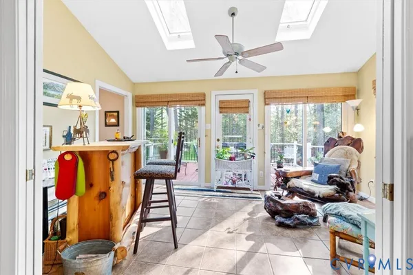 a kitchen with stainless steel appliances kitchen island granite countertop a refrigerator a stove top oven a sink dishwasher and dining table with wooden floor