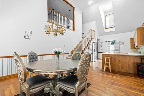 a dining room with furniture and wooden floor