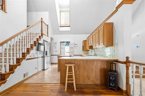 a view of a kitchen with furniture and staircase