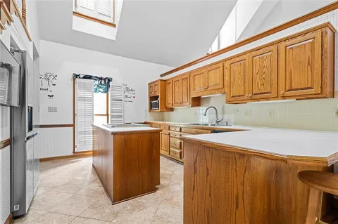 a kitchen with stainless steel appliances granite countertop a refrigerator and a sink